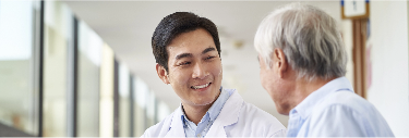 Male physician speaking with senior