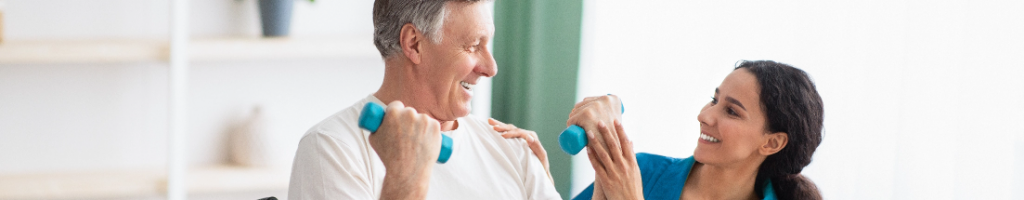 Therapist assisting a senior with dumbbell curl