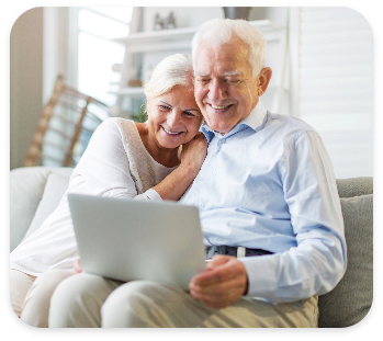 Senior couple reviewing healthcare options on laptop